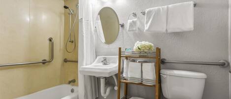 A bathroom with a bathtub, a sink, a toilet, and a shower.
