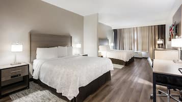 Deluxe Room, 2 Queen Beds (Smoke Free) | Desk, laptop workspace, blackout drapes, iron/ironing board