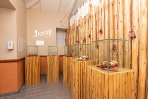 A spa area with wooden partitions and glass display cases containing various items.