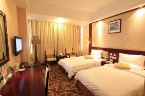 A hotel room with two beds, a desk, a chair, a television, and a window with curtains. - Golden Spring Hotel (Kunming)