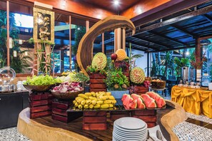 A buffet with various fruits and vegetables, including bananas, watermelon, and pineapple. - Princess Kamala Beachfront Hotel Phuket (Kamala)