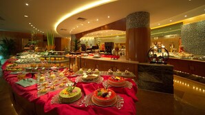 A buffet with various food items and desserts. - Songjiang New Century Grand Hotel Shanghai (Shanghai)
