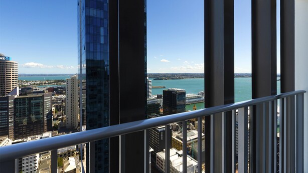 A high-rise building with a view of a cityscape and a body of water. - Auckland Harbour Suites (Auckland)