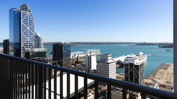 A cityscape with modern buildings, a waterfront, and a clear sky.