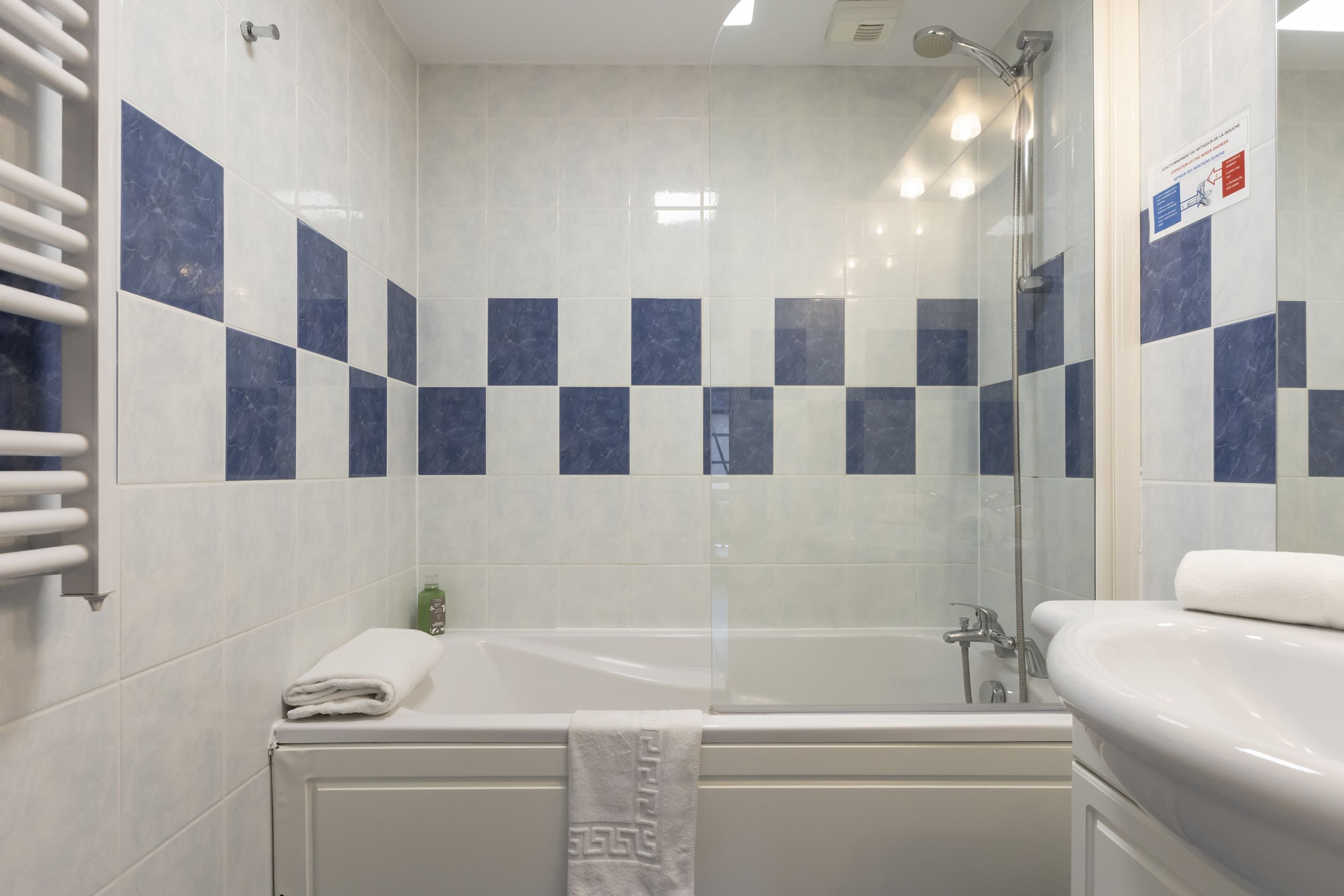 A bathroom with a bathtub, a shower, and a sink.