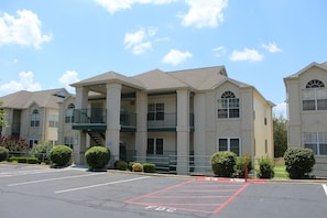 A multi-story building with a parking lot marked with 'FDC' and 'No Parking' signs. - Branson Condo Resorts by Andy Williams Theatre (Branson)