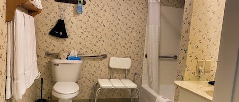 A bathroom with a toilet, a shower, and a bathtub.