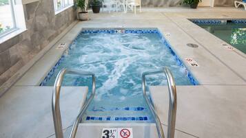 An indoor swimming pool with a 3 1/2 ft depth, no diving sign, and a tiled edge.
