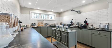 A modern kitchen with a long counter, built-in appliances, and ample storage.