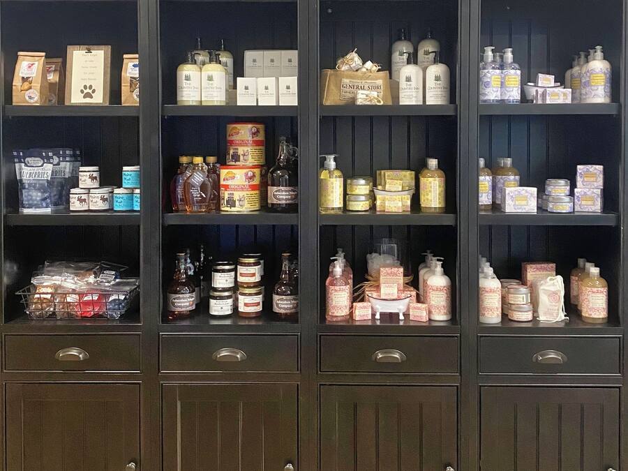 A display of The Country Inn Mercantile with various products including food items, beverages, and toiletries.