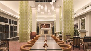 A conference room with a long table, chairs, and a fireplace.