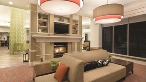 A modern living room with a fireplace, a sofa, and a television.