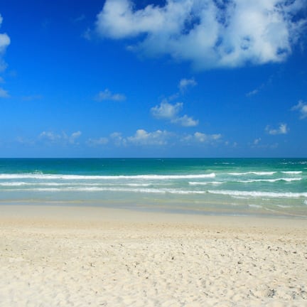 On the beach, white sand, sun-loungers, beach umbrellas