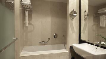 A modern bathroom with a bathtub, a sink, and a shower area.