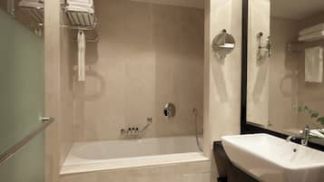 Un baño moderno con bañera, lavabo y espejo.