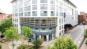 A modern hotel with a curved facade, multiple floors, and large windows. - Travelodge Windsor Central (Windsor)