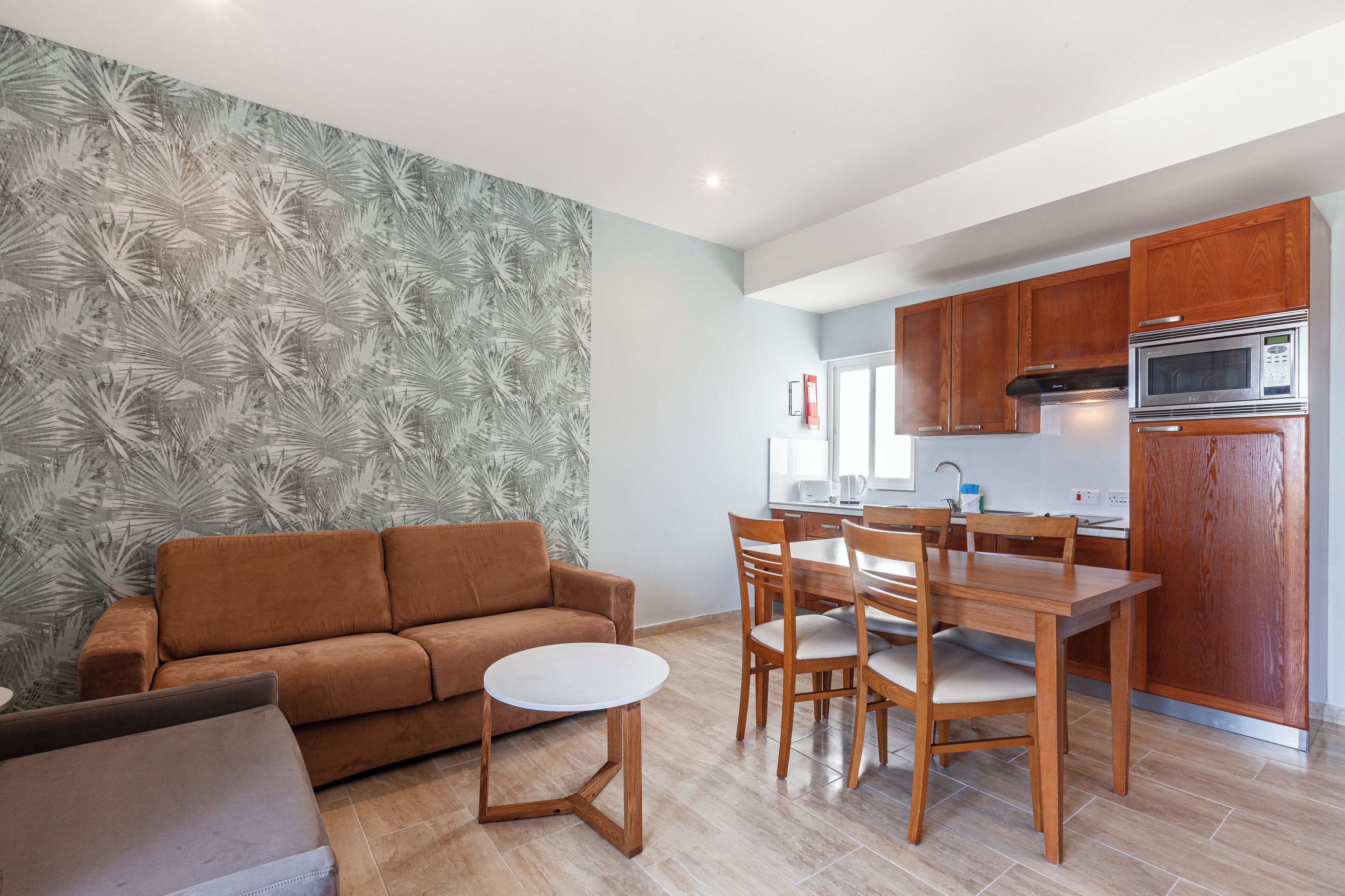 A modern kitchen with wooden cabinets and a built-in microwave.