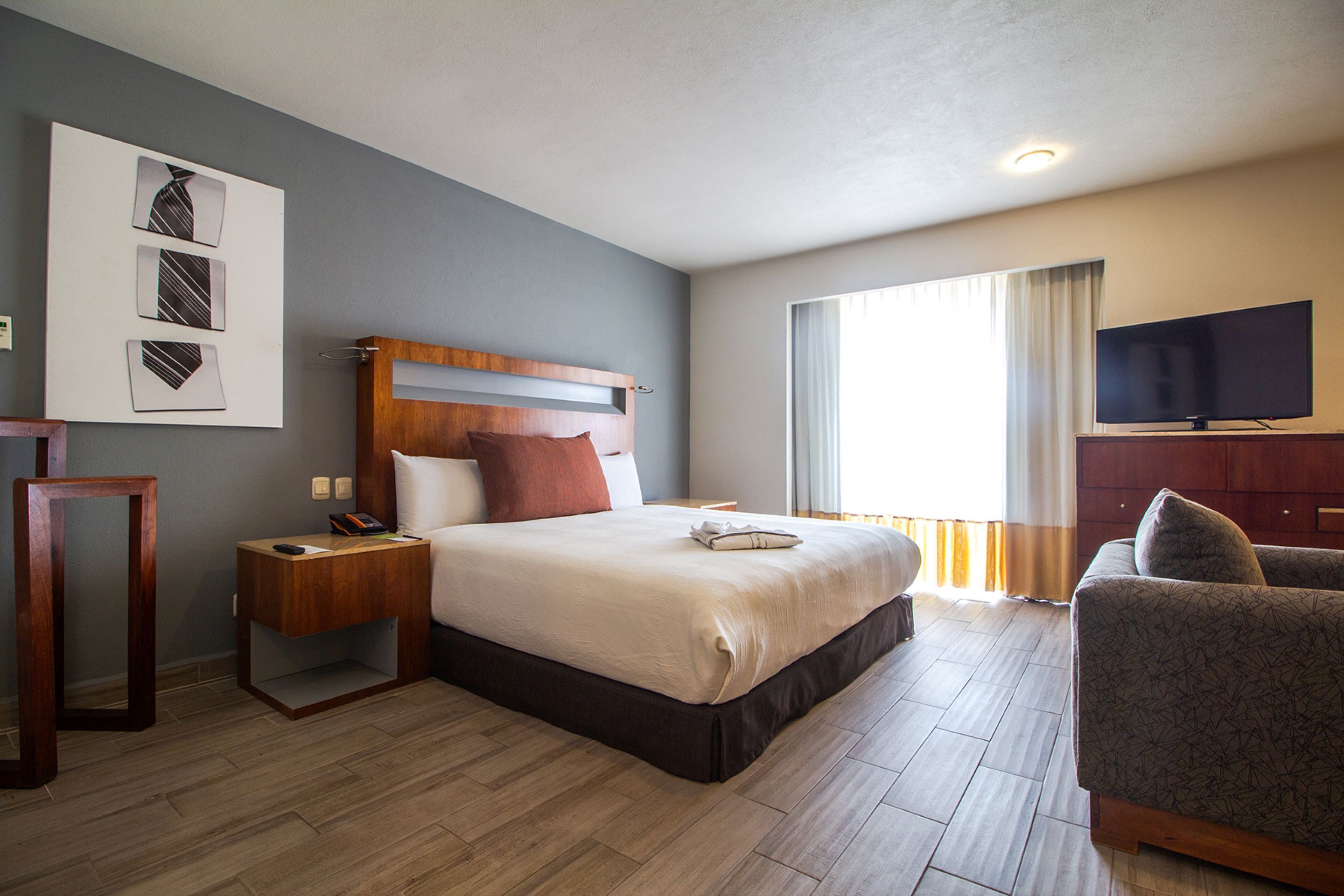 junior suite | in-room safe, desk, blackout curtains, iron/ironing board