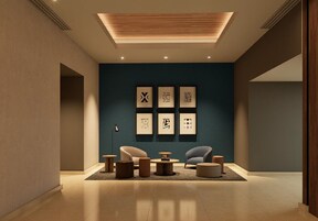 Un interior moderno con una pared de acento azul oscuro, obra de arte enmarcadas y muebles contemporáneos.