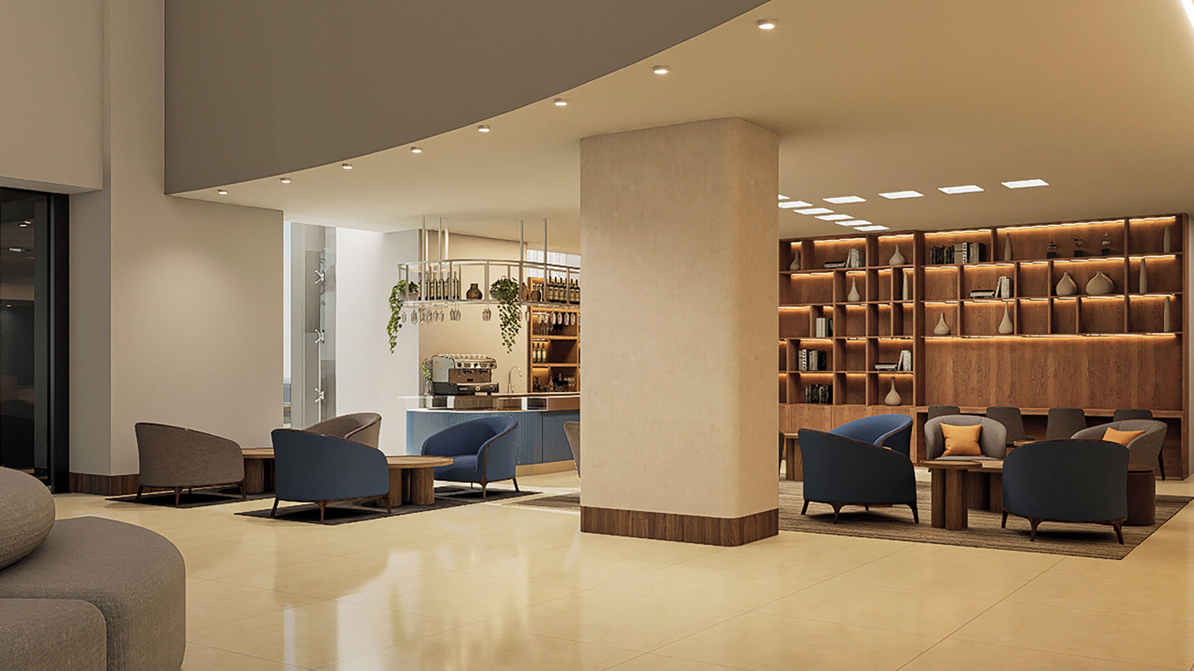 A modern lobby with a reception desk, seating area, and a bookshelf.