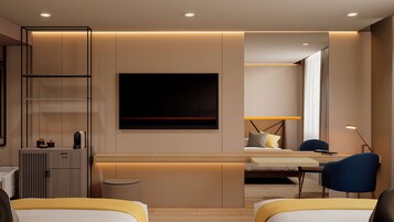 Una habitación de hotel moderna con cama, escritorio, silla y un televisor de pantalla plana grande.