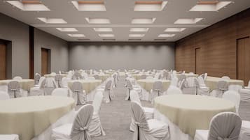 A conference room with multiple tables and chairs, arranged in rows.