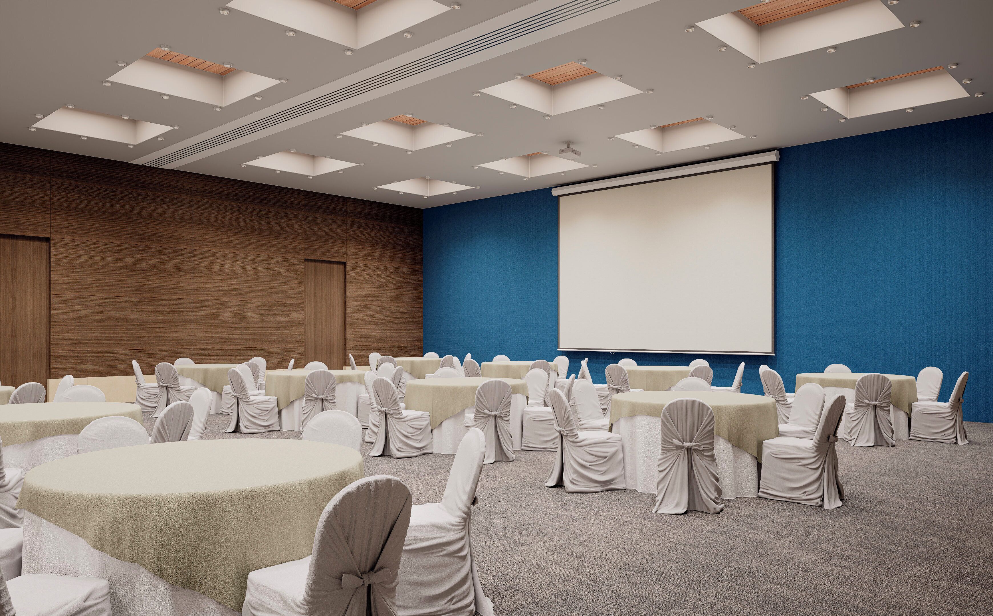 A conference room with round tables, chairs, a projector screen, and a blue accent wall.