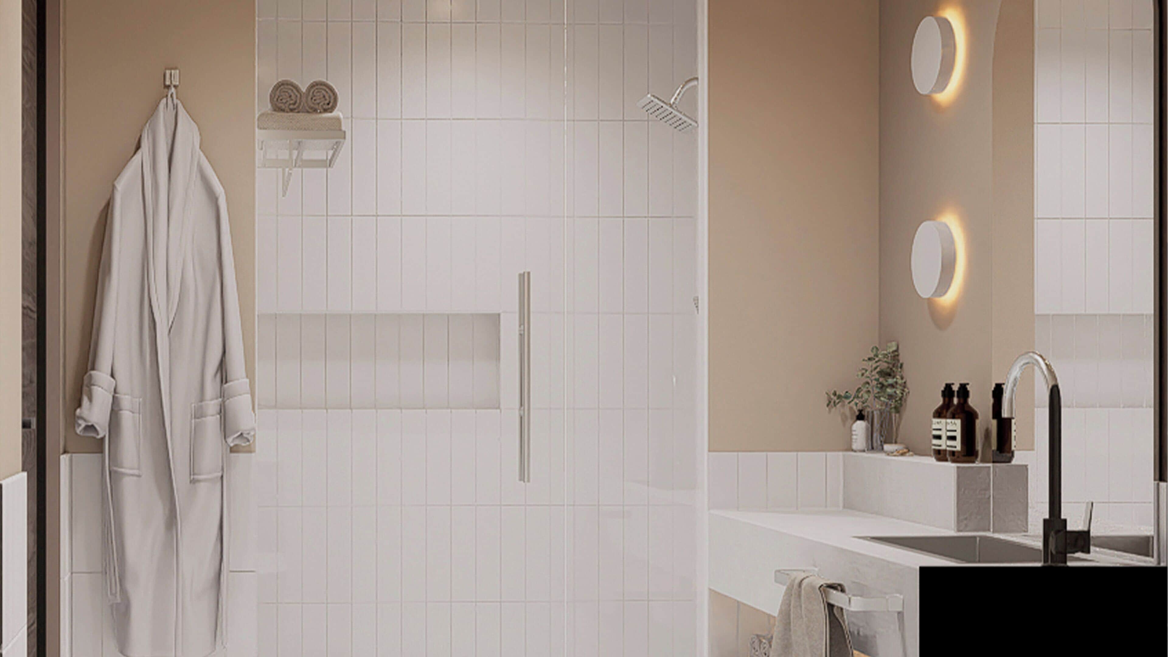 A modern bathroom with a walk-in shower, a towel rack, and a sink area with a mirror and toiletries.