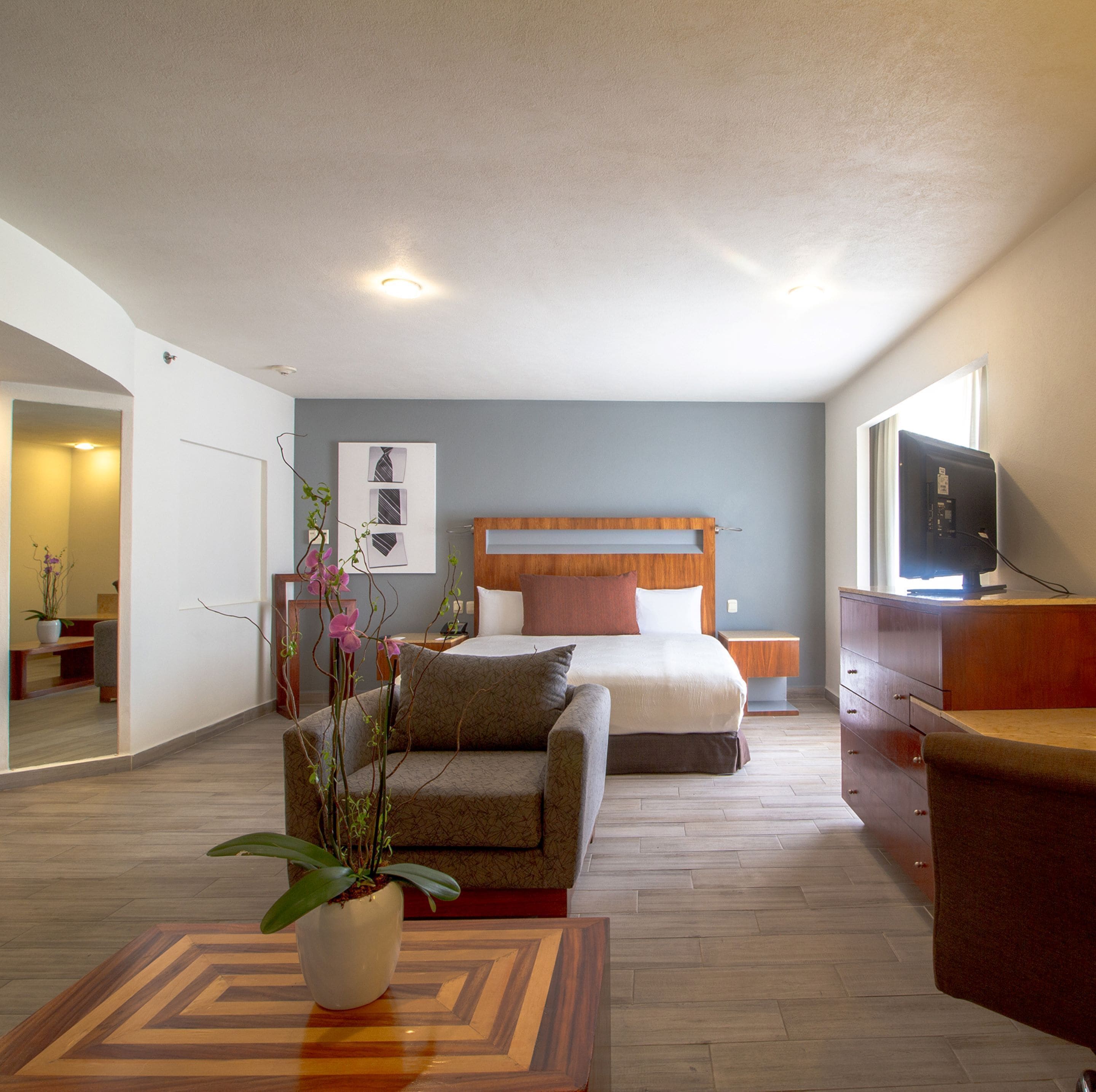 junior suite | in-room safe, desk, blackout curtains, iron/ironing board