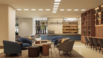 Un área de descanso moderna con asientos, una barra y una exhibición de vinos.