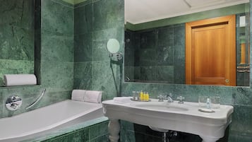 Ein Badezimmer mit einer Badewanne, einem Waschbecken und einem Spiegel.