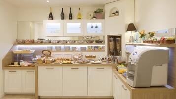 A modern kitchen with a central island, a coffee machine, and various food items displayed on shelves.