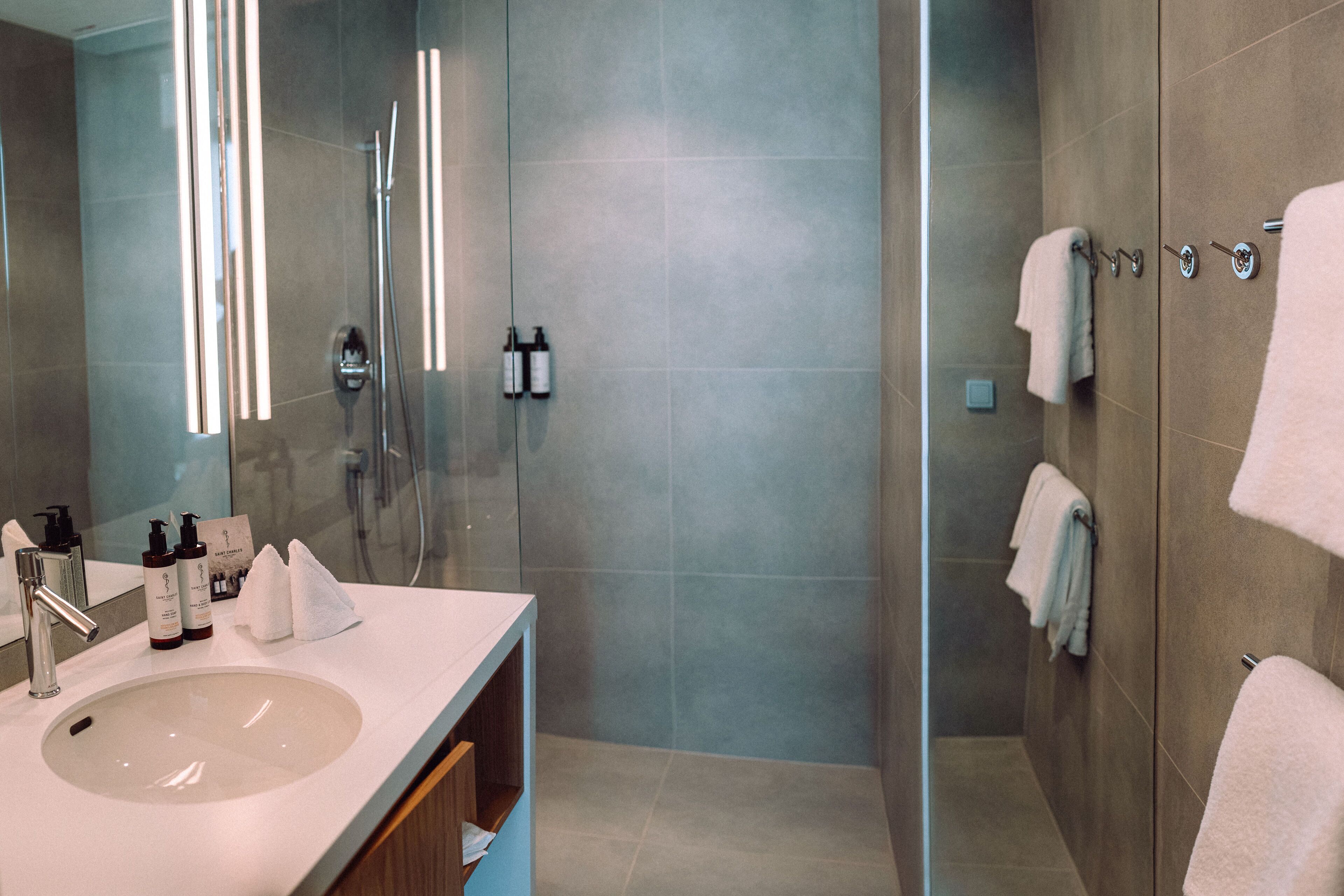 designer toiletries, hair dryer, bathrobes, slippers