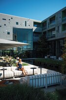 A modern outdoor seating area with a pool and lounge chairs.