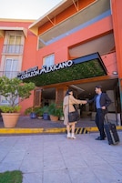 A hotel entrance with a sign for 'Hotel Suites Corazon Mexicano.'