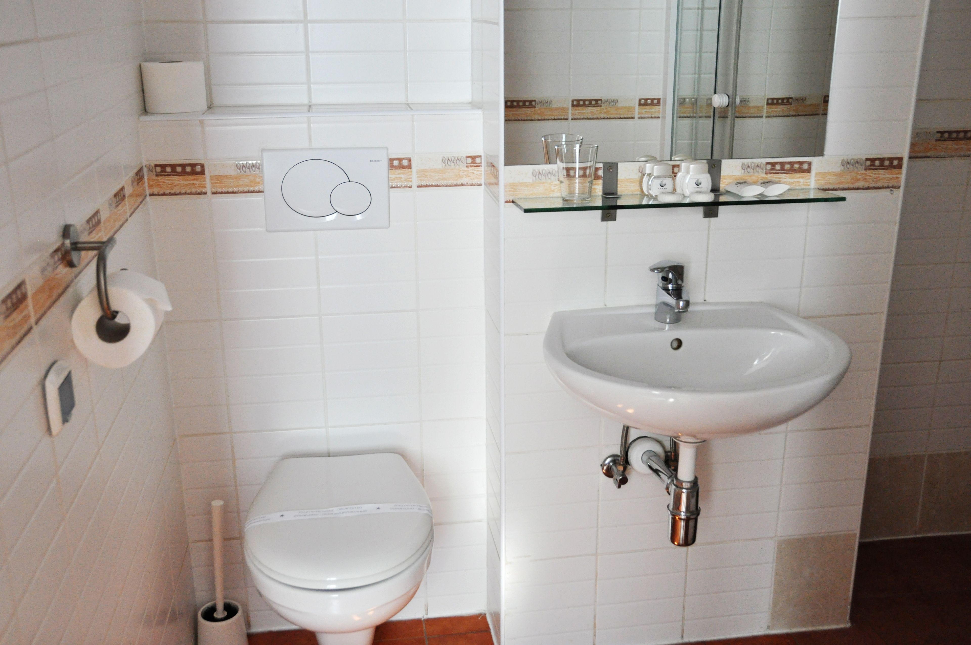 shower, hair dryer, towels, toilet paper