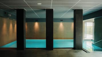 Indoor pool, open 7:00 AM to 11:00 PM, pool loungers