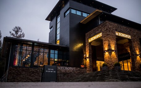 A modern hotel with a brick facade and large windows.
