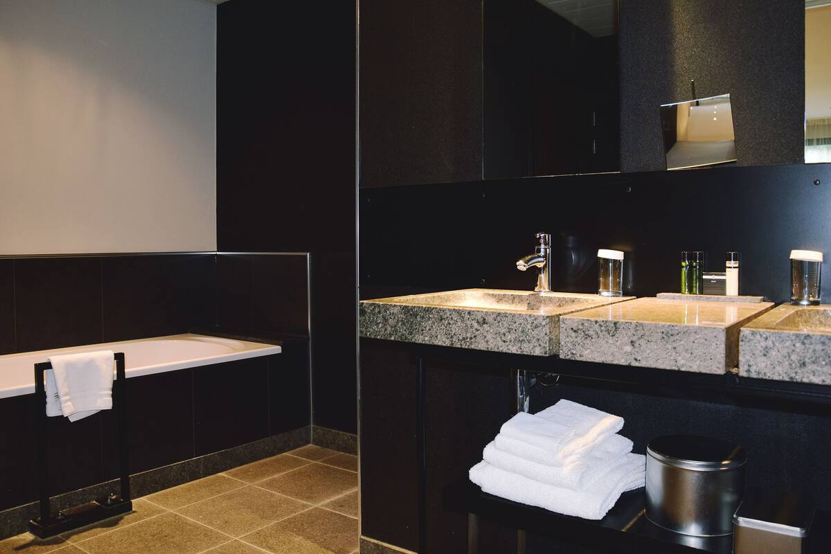 suite, 1 king bed | bathroom | separate bathtub and shower, designer toiletries, hair dryer, bathrobes