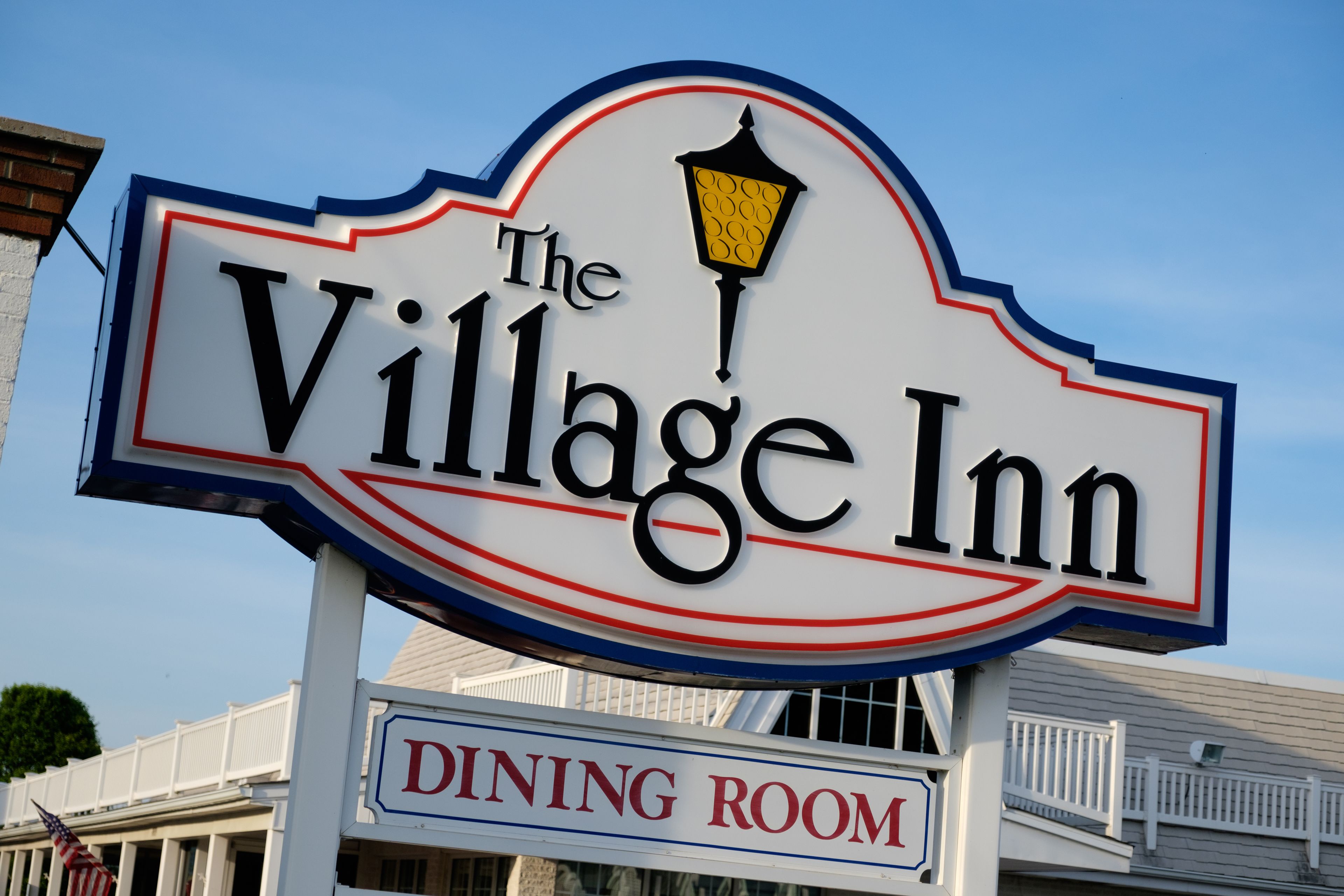 A sign for The Village Inn with a dining room label.