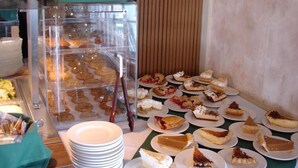 A bakery display with various pastries and desserts.