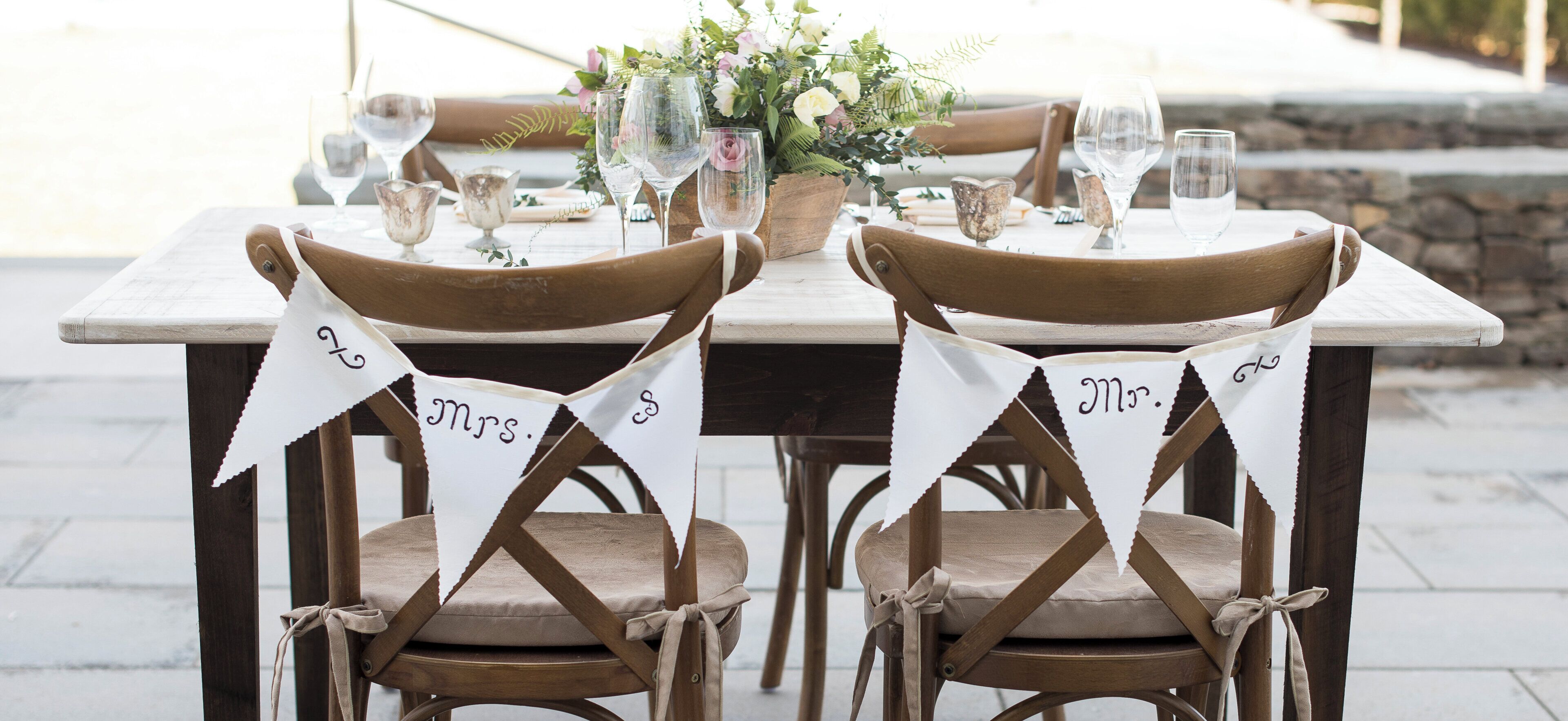 A wooden dining table with chairs, each with a name tag.