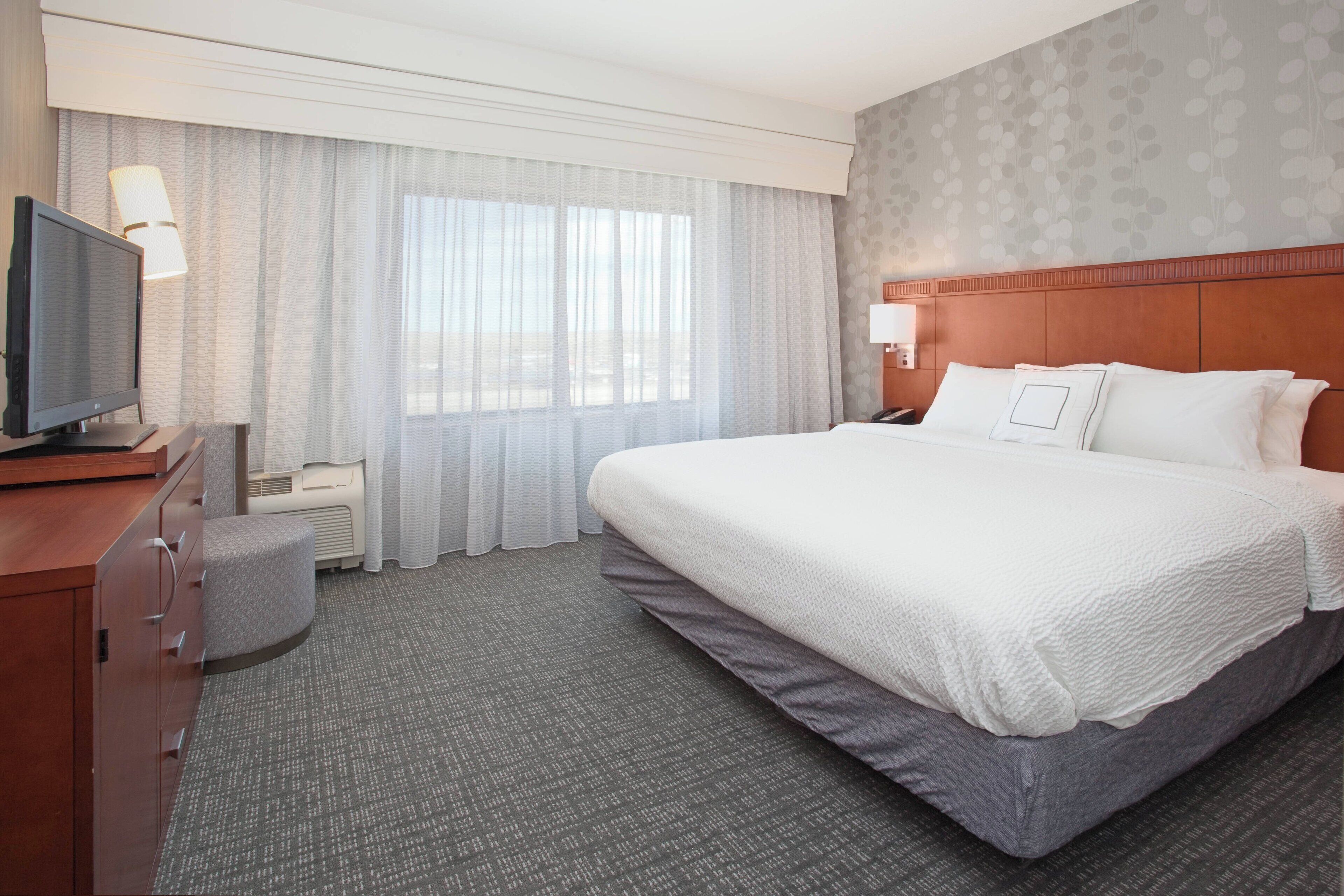 pillow-top beds, desk, laptop workspace, blackout curtains