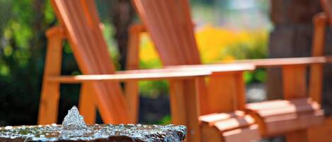 A wooden table and chairs in an outdoor setting.