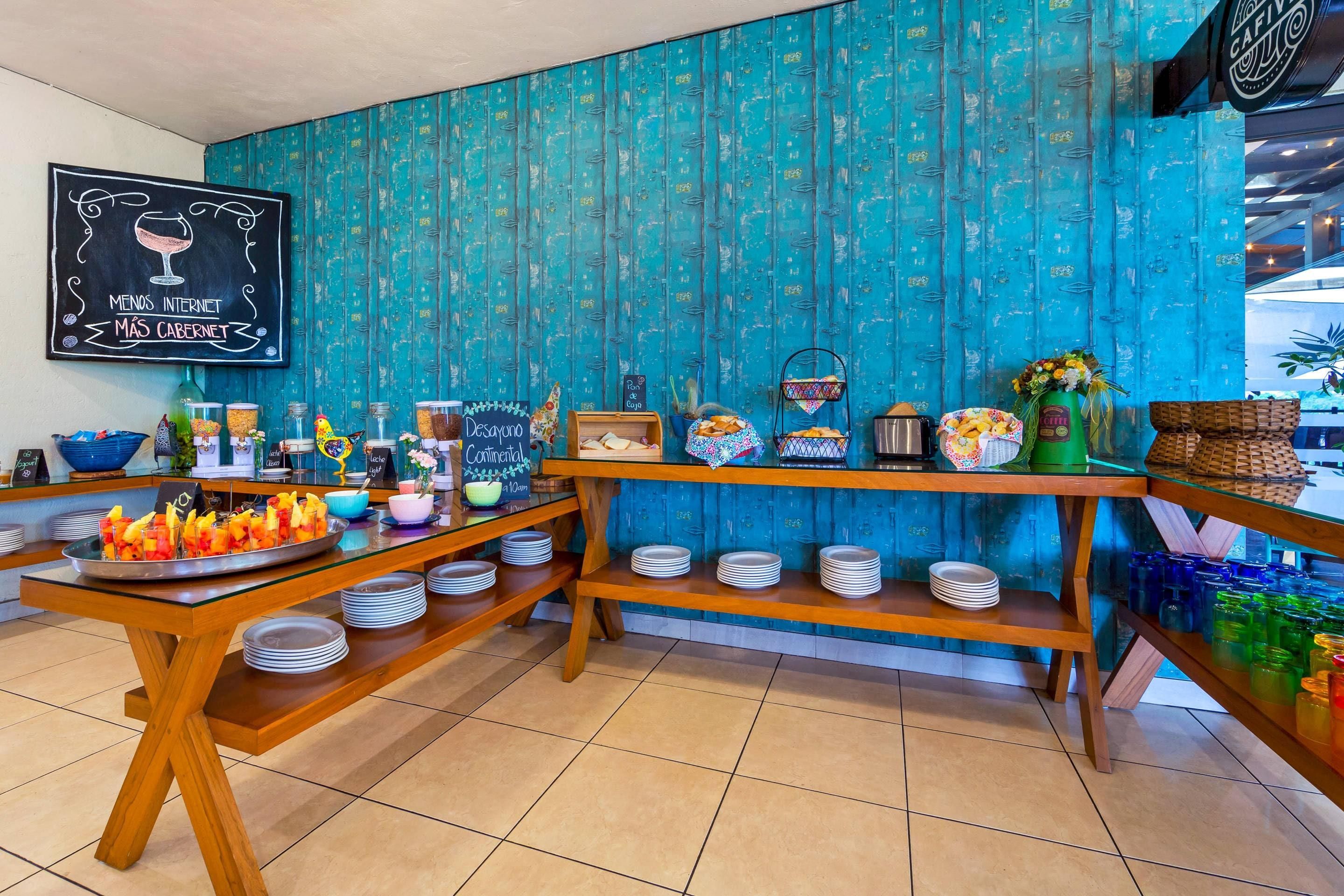 A breakfast buffet with various food items and a chalkboard sign.