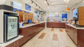 A modern kitchen area with a refrigerator, coffee machine, and various food items on the counter. - Holiday Inn Express Hotel & Suites Medford-Central Point by IHG (Central Point)