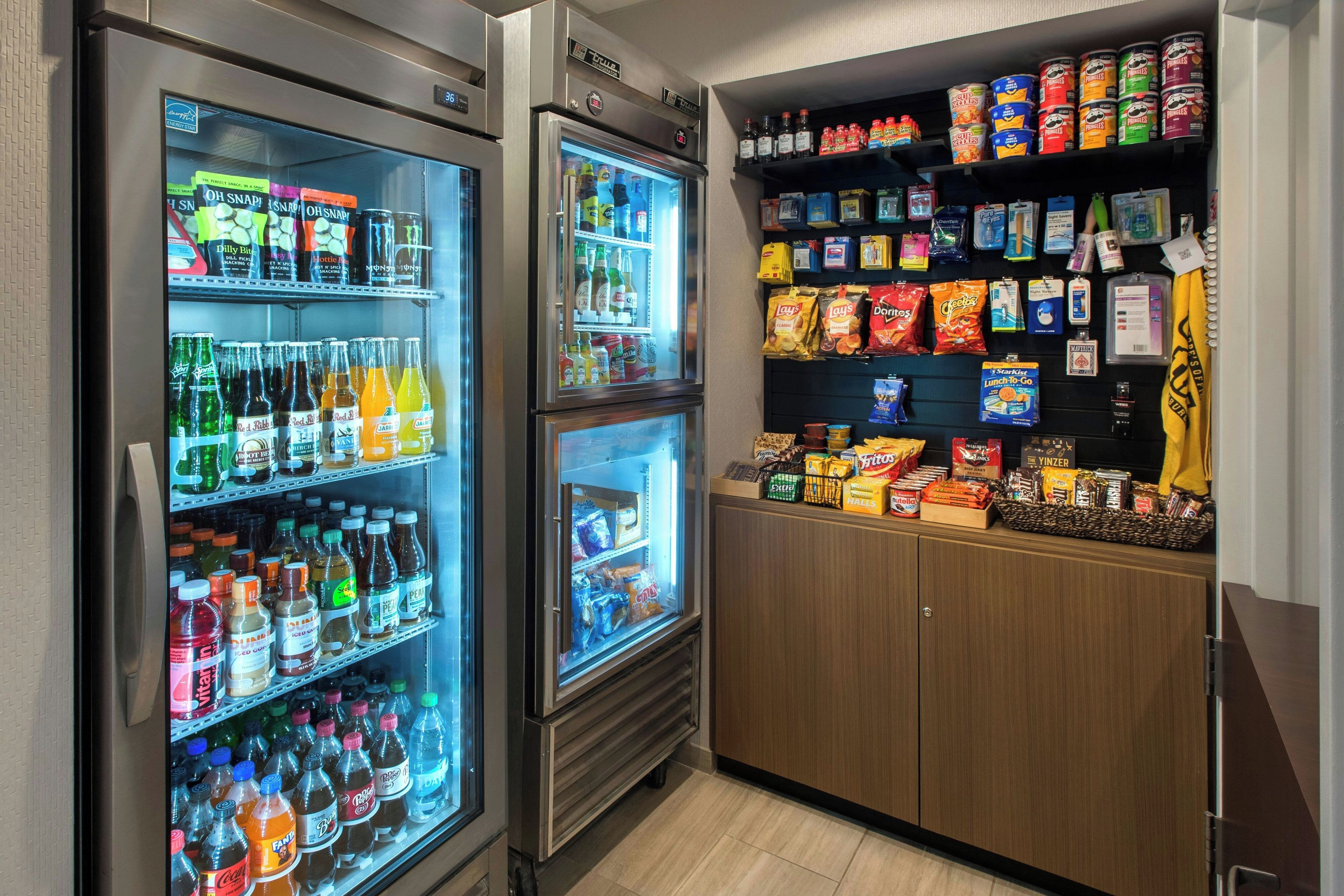 A vending area with multiple beverage dispensers and snack shelves.
