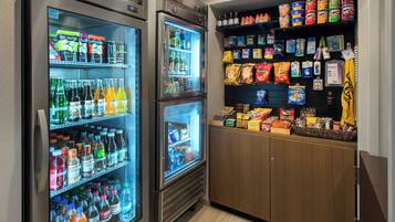 A vending area with multiple beverage dispensers and snack shelves.