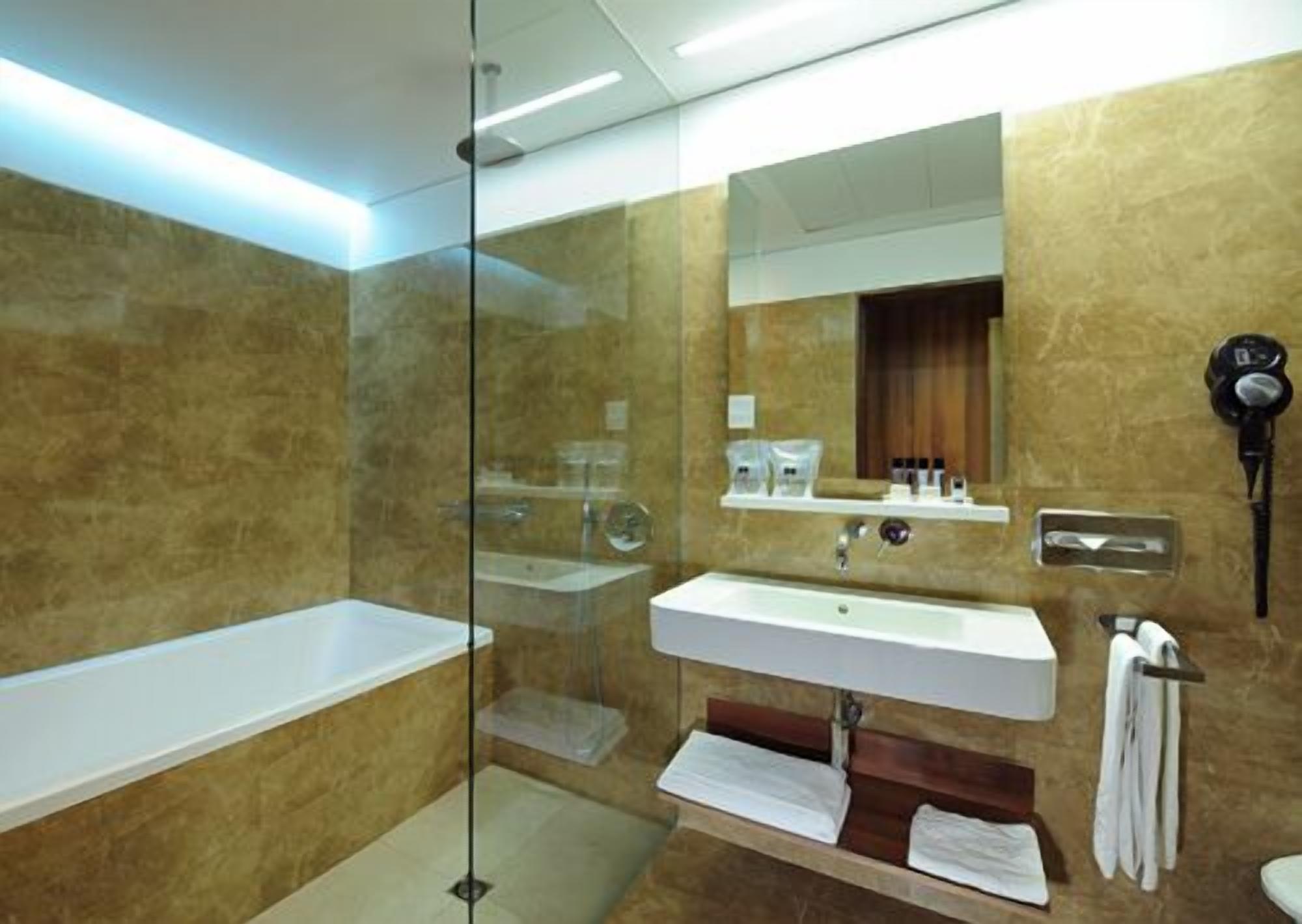 deluxe suite | bathroom | hair dryer, bidet, towels