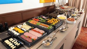 A buffet with various food items including meats, cheeses, and vegetables. - City Hotels Rūdninkai (Vilnius)